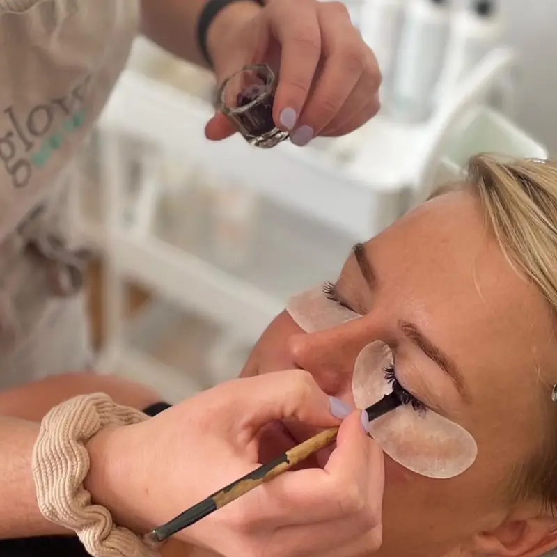 A lash lift in progress, lashes set on a shield over a client's eye