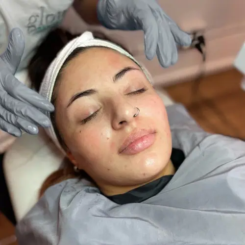 A client after treatment, eyes closed, brows clean and skin bright